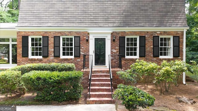 2179 Mountclaire Ct, Stone Mountain, GA 30087 - entrance to property featuring roof with shingles, brick siding, and mansard roof