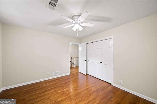 2179 Mountclaire Ct, Stone Mountain, GA 30087 - unfurnished bedroom featuring wood finished floors, a closet, and a ceiling fan