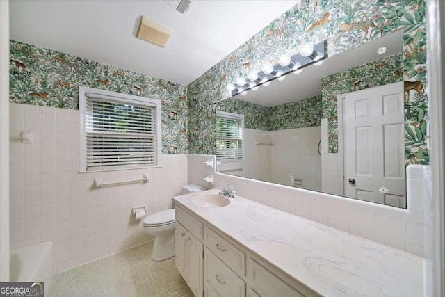 2179 Mountclaire Ct, Stone Mountain, GA 30087 - bathroom featuring wallpapered walls, double vanity, tile patterned flooring, tile walls, and wainscoting