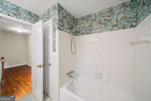 2179 Mountclaire Ct, Stone Mountain, GA 30087 - bathroom featuring wallpapered walls and washtub / shower combination