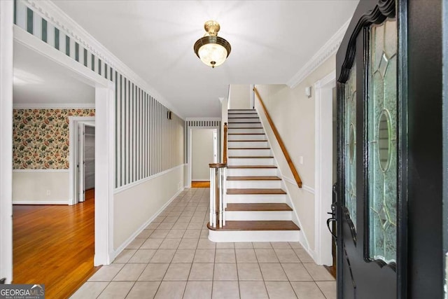 2179 Mountclaire Ct, Stone Mountain, GA 30087 - foyer with stairway, crown molding, light tile patterned floors, wallpapered walls, and a wainscoted wall
