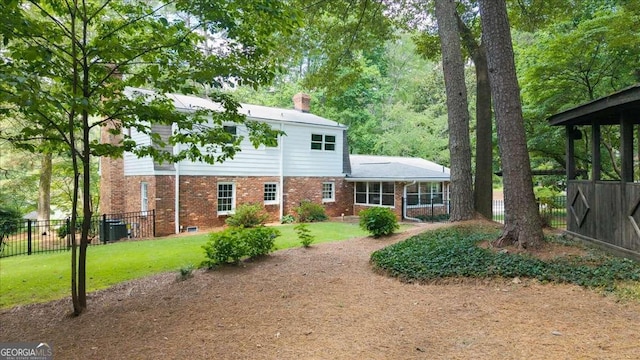 2179 Mountclaire Ct, Stone Mountain, GA 30087 - back of house featuring brick siding and a chimney
