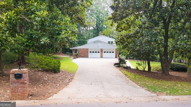 2179 Mountclaire Ct, Stone Mountain, GA 30087 - view of front of property featuring brick siding, concrete driveway, a garage, and view of scattered trees