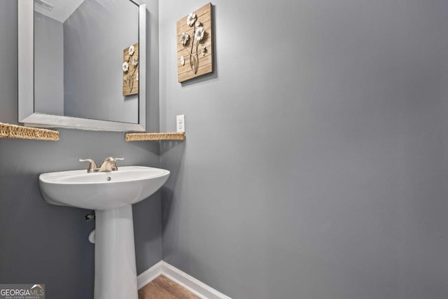 6422 Woodland Station Dr, Lula, GA 30554 - bathroom with baseboards and wood finished floors
