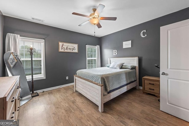 6422 Woodland Station Dr, Lula, GA 30554 - bedroom with multiple windows, wood finished floors, and a ceiling fan