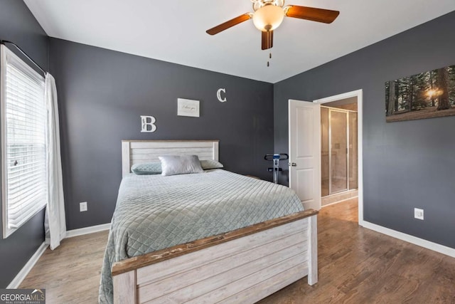 6422 Woodland Station Dr, Lula, GA 30554 - bedroom with wood finished floors, ceiling fan, and ensuite bathroom