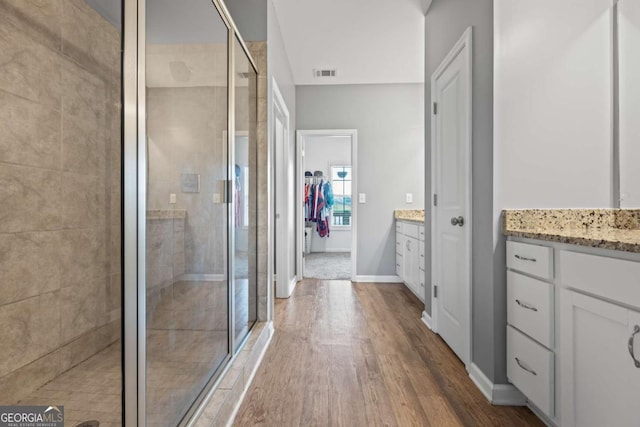 6422 Woodland Station Dr, Lula, GA 30554 - full bathroom featuring a stall shower, vanity, wood finished floors, and a spacious closet