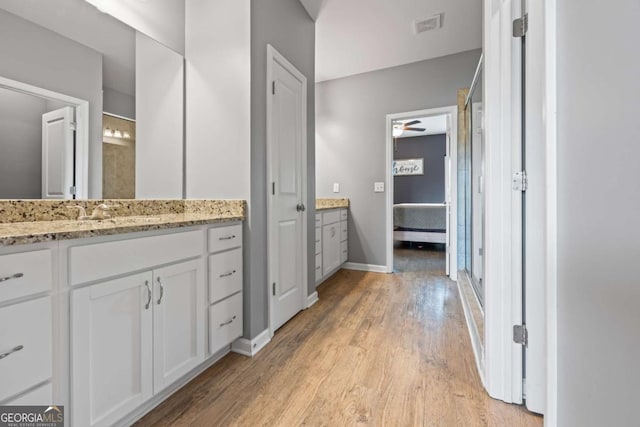 6422 Woodland Station Dr, Lula, GA 30554 - ensuite bathroom with vanity, ceiling fan, and wood finished floors