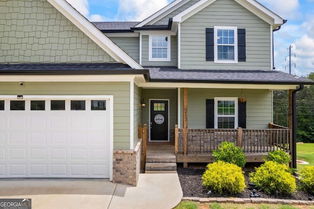 6422 Woodland Station Dr, Lula, GA 30554 - view of front of house with covered porch, driveway, a garage, and a shingled roof