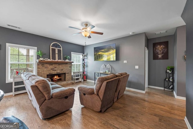 6422 Woodland Station Dr, Lula, GA 30554 - living room featuring a ceiling fan, healthy amount of natural light, wood finished floors, and a brick fireplace