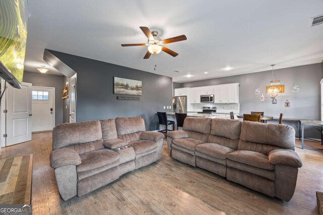 6422 Woodland Station Dr, Lula, GA 30554 - living area with a ceiling fan and light wood finished floors