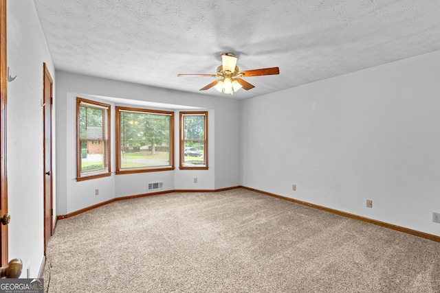 23-25 Sentry Oak Ct, Stockbridge, GA 30281 - unfurnished room with carpet flooring, a ceiling fan, and a textured ceiling