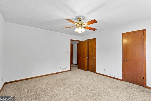 23-25 Sentry Oak Ct, Stockbridge, GA 30281 - unfurnished bedroom with carpet floors, a closet, and ceiling fan
