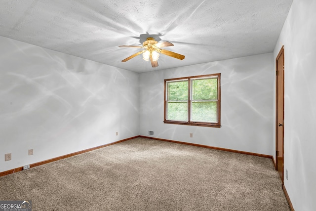 23-25 Sentry Oak Ct, Stockbridge, GA 30281 - spare room featuring ceiling fan, carpet floors, and a textured ceiling