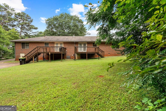23-25 Sentry Oak Ct, Stockbridge, GA 30281 - rear view of house featuring stairway, brick siding, a yard, and a wooden deck