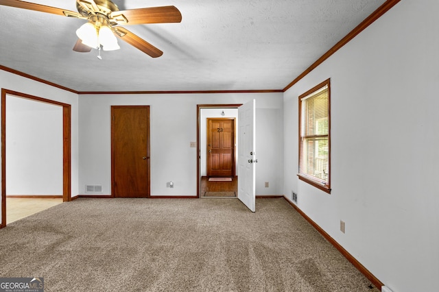 23-25 Sentry Oak Ct, Stockbridge, GA 30281 - carpeted empty room with crown molding, a ceiling fan, and a textured ceiling