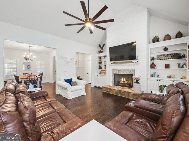105 Crestview Dr, Jefferson, GA 30549 - living room with ceiling fan, a chandelier, dark wood-style flooring, vaulted ceiling, and a lit fireplace