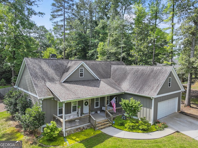 105 Crestview Dr, Jefferson, GA 30549 - view of front facade featuring a porch, a garage, roof with shingles, driveway, and a front lawn