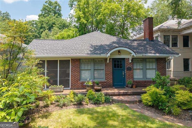 1300 N Ave NE, Atlanta, GA 30307 - view of front facade with brick siding, a chimney, and a shingled roof
