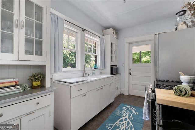1300 N Ave NE, Atlanta, GA 30307 - kitchen with stainless steel appliances, white cabinets, light countertops, and glass insert cabinets