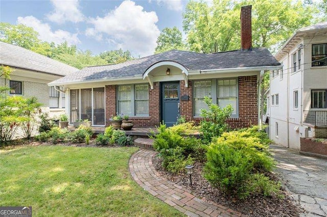 1300 N Ave NE, Atlanta, GA 30307 - view of front of property featuring brick siding, a front lawn, and a chimney