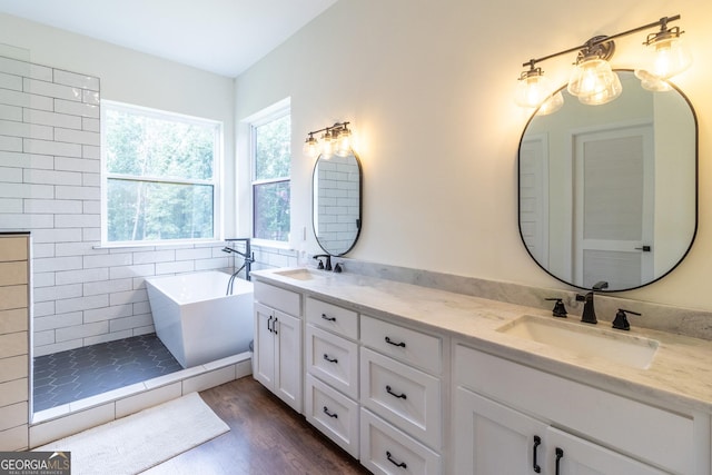4384 Round Pond Rd, Lafayette, GA 30728 - bathroom with a freestanding tub, double vanity, wood finished floors, and tiled shower