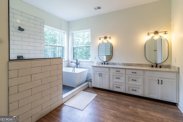 4384 Round Pond Rd, Lafayette, GA 30728 - bathroom featuring double vanity, a freestanding tub, wood finished floors, and tiled shower