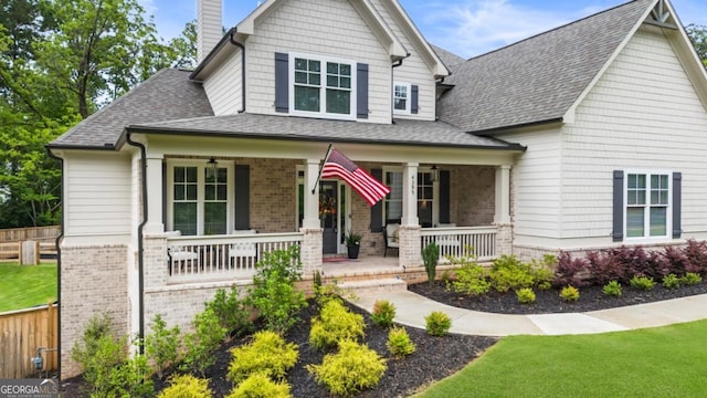 4395 Capstone Ct, Roswell, GA 30075 - craftsman house with covered porch, a ceiling fan, brick siding, and a shingled roof