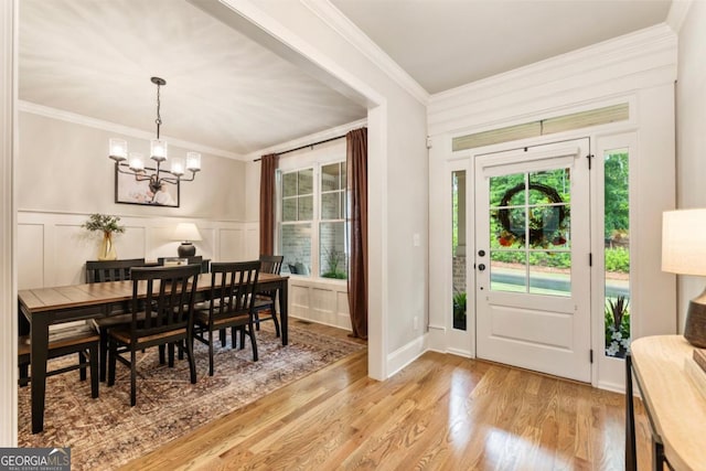 4395 Capstone Ct, Roswell, GA 30075 - dining room featuring crown molding, plenty of natural light, a chandelier, a decorative wall, and light wood-style floors