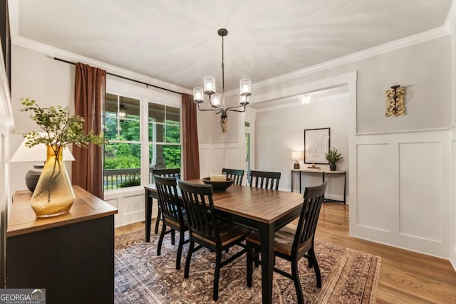 4395 Capstone Ct, Roswell, GA 30075 - dining area featuring a decorative wall, ornamental molding, a chandelier, wood finished floors, and wainscoting