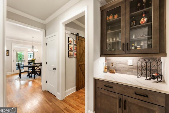 4395 Capstone Ct, Roswell, GA 30075 - bar area with light wood finished floors, a barn door, crown molding, decorative backsplash, and a chandelier