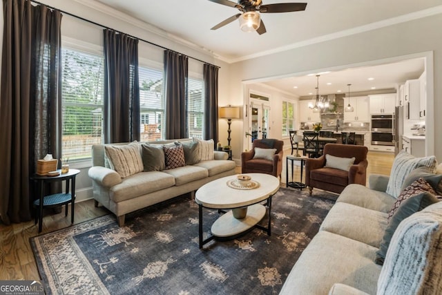 4395 Capstone Ct, Roswell, GA 30075 - living area featuring crown molding, wood finished floors, ceiling fan, and a chandelier