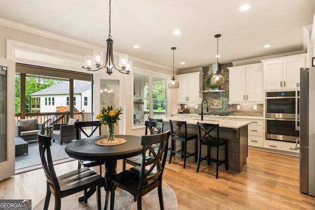 4395 Capstone Ct, Roswell, GA 30075 - dining area with ornamental molding, healthy amount of natural light, a chandelier, light wood finished floors, and recessed lighting