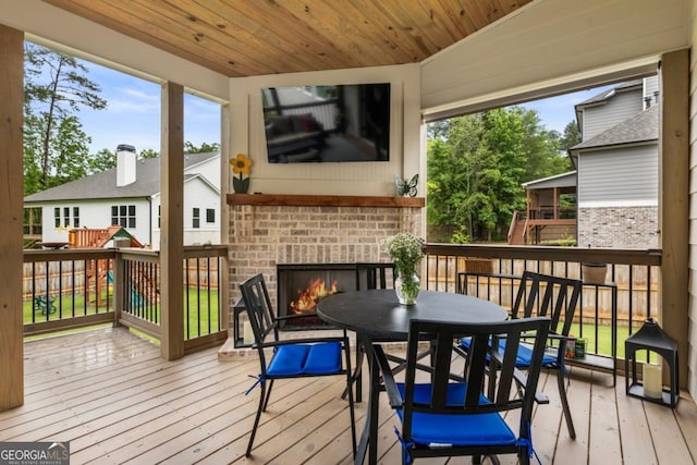 4395 Capstone Ct, Roswell, GA 30075 - wooden deck with an outdoor brick fireplace and outdoor dining area