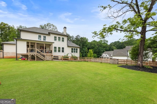 4395 Capstone Ct, Roswell, GA 30075 - rear view of property featuring a sunroom, a chimney, a fenced backyard, and a shingled roof