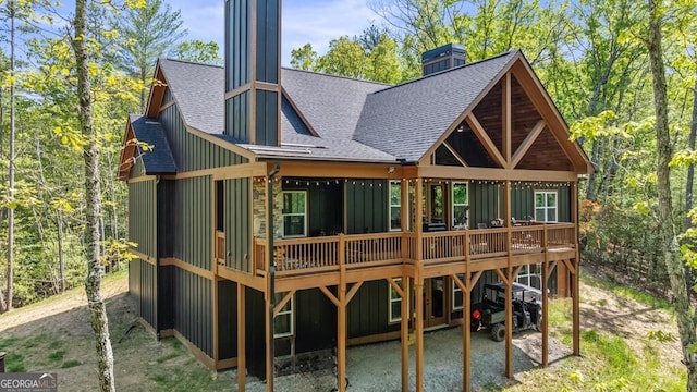 595 Arp Rd, Mineral Bluff, GA 30559 - back of property featuring a shingled roof, board and batten siding, a deck, and a chimney