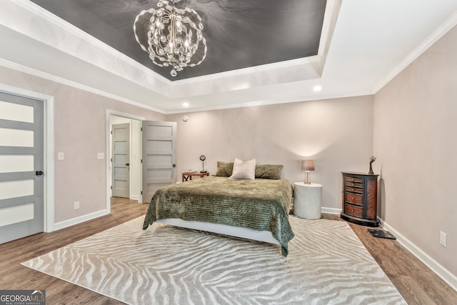 980 Casteel Rd, Powder Springs, GA 30127 - bedroom featuring a raised ceiling, a chandelier, wood finished floors, crown molding, and recessed lighting