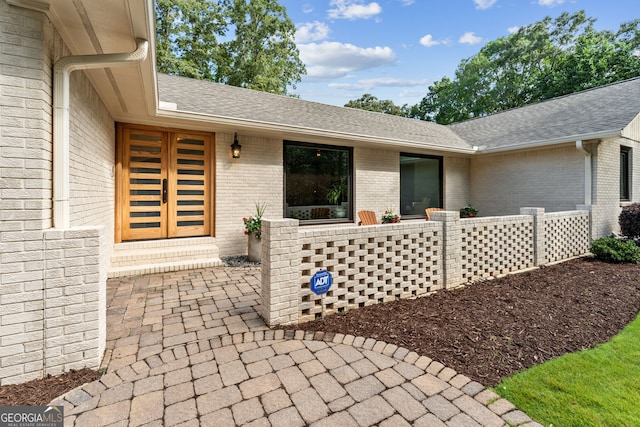 980 Casteel Rd, Powder Springs, GA 30127 - view of exterior entry with brick siding and a shingled roof
