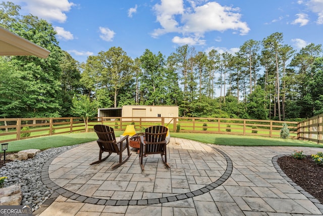 980 Casteel Rd, Powder Springs, GA 30127 - fenced backyard with a patio, a fire pit, view of scattered trees, and an outdoor structure