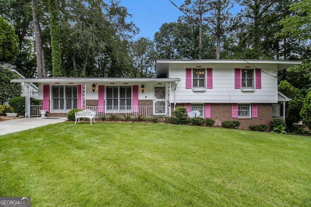 2983 Peek Rd NW, Atlanta, GA 30318 - split level home featuring brick siding, a porch, and a front yard