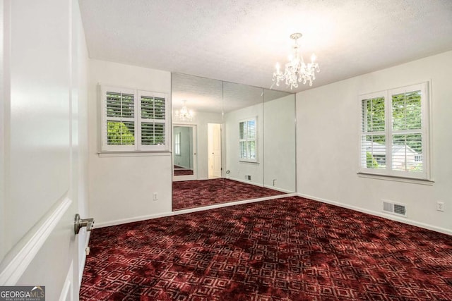 2983 Peek Rd NW, Atlanta, GA 30318 - spare room with a chandelier and a textured ceiling