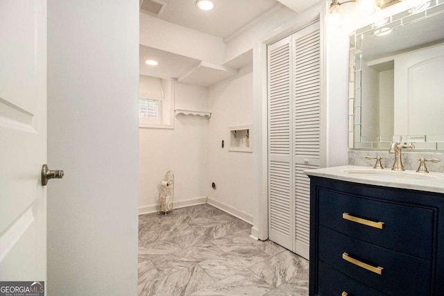 2983 Peek Rd NW, Atlanta, GA 30318 - bathroom with a closet, vanity, marble finish flooring, and recessed lighting