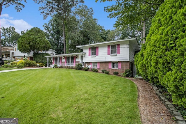 2983 Peek Rd NW, Atlanta, GA 30318 - split level home with a porch, brick siding, and a front lawn