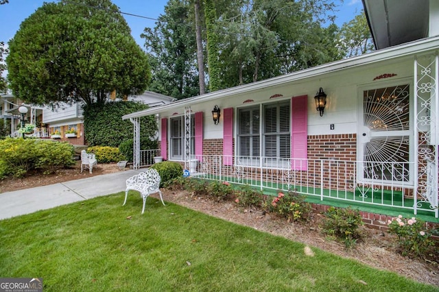 2983 Peek Rd NW, Atlanta, GA 30318 - view of front of home featuring a porch, brick siding, and a front lawn