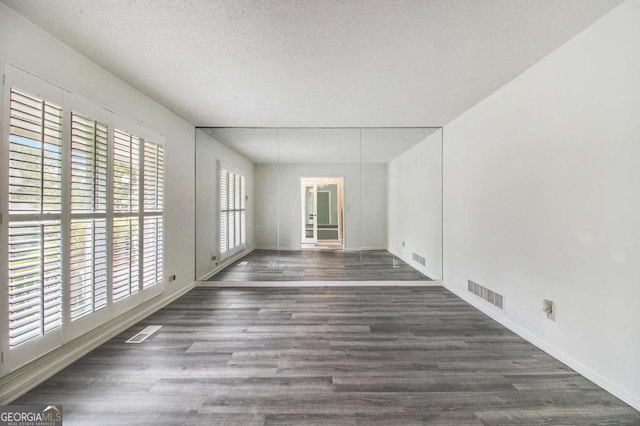 2983 Peek Rd NW, Atlanta, GA 30318 - empty room with wood finished floors and a textured ceiling