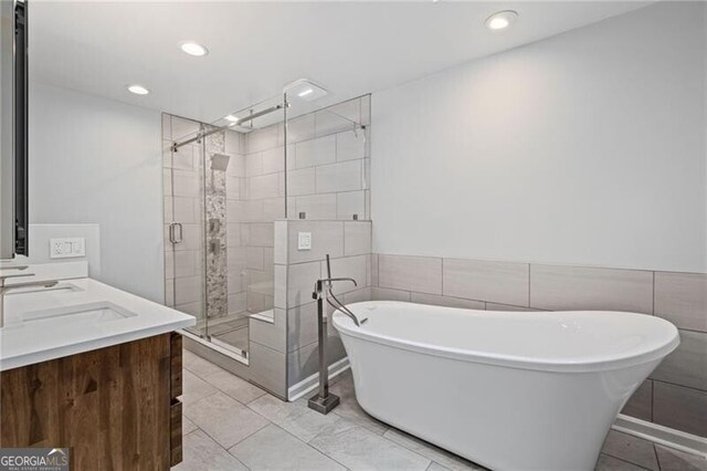 1279 Colony Pl, Marietta, GA 30068 - bathroom with a shower stall, a soaking tub, recessed lighting, double vanity, and tile walls