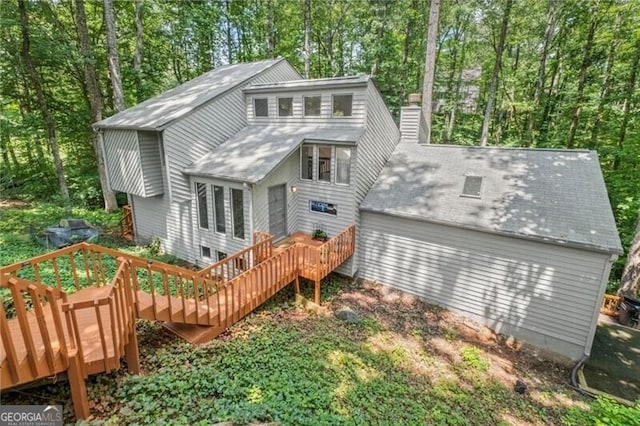1279 Colony Pl, Marietta, GA 30068 - rear view of house featuring a wooden deck, a chimney, and view of scattered trees