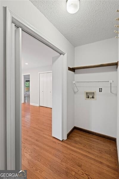 1279 Colony Pl, Marietta, GA 30068 - laundry room with hookup for a washing machine, light wood finished floors, and a textured ceiling
