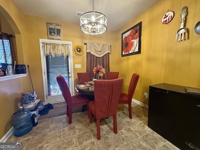 942 Amelia Dr, Byron, GA 31008 - dining space with a chandelier and arched walkways