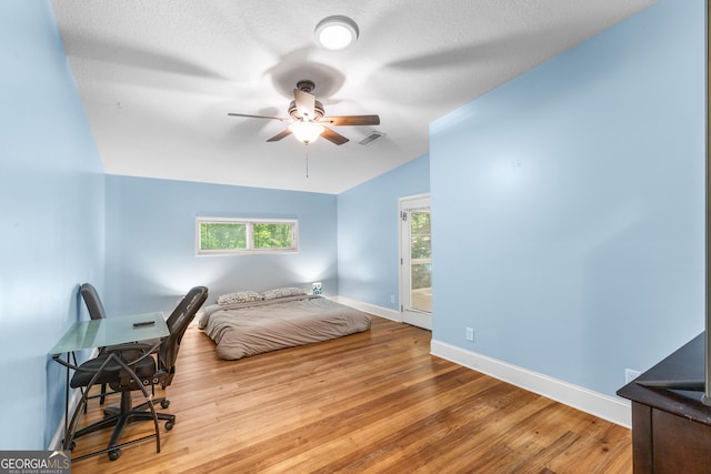 6567 Tahiti Way, Flowery Branch, GA 30542 - bedroom with wood finished floors and ceiling fan